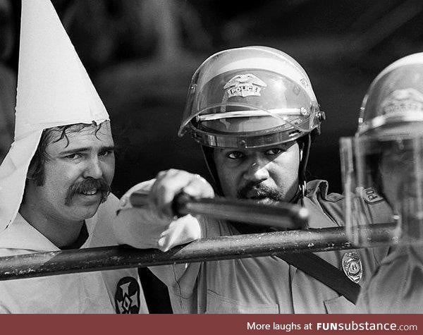 Police protect KKK member as protesters close in during a rally, Austin, Texas, circa