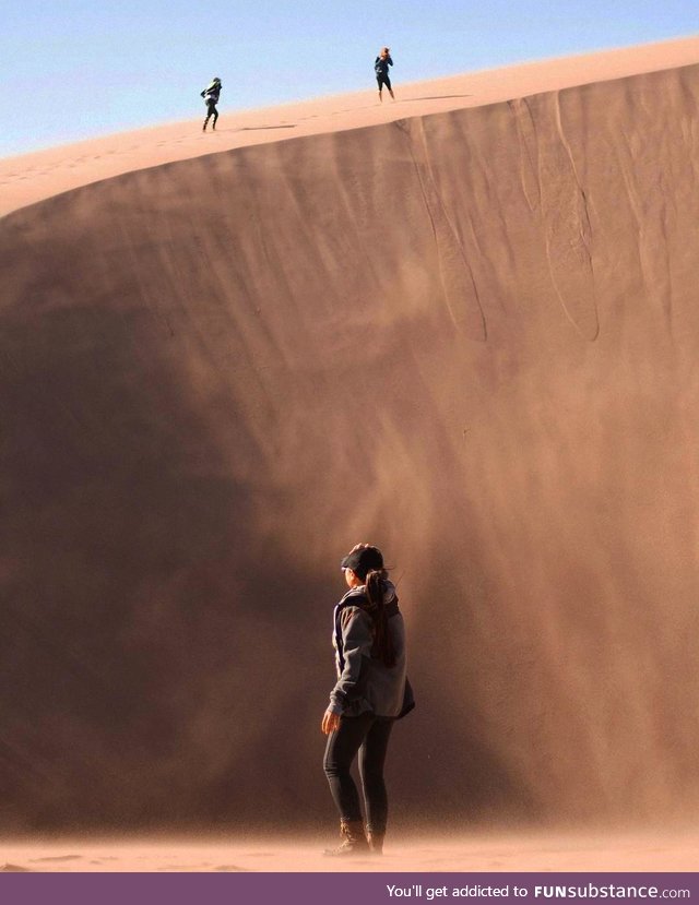 My girlfriend & I exploring Great Sand Dunes while 2 strangers hike ahead