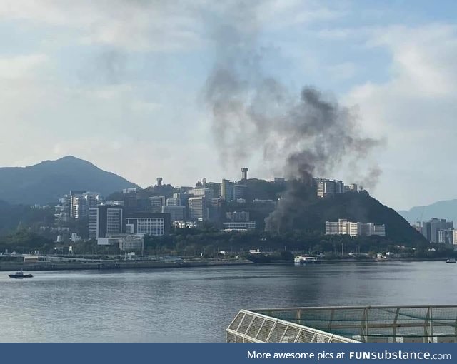 Smoke from TEAR GAS over a college campus, CUHK, in Hong Kong, where the police entered