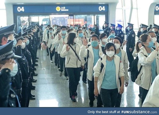 Chinese police saluting the heroic doctors and nurses before leaving wuhan