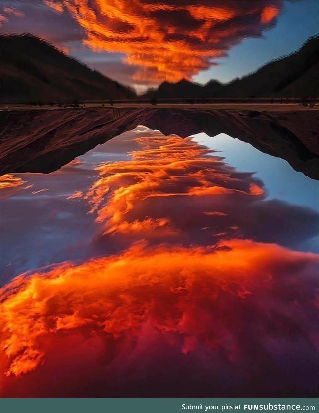 Lake reflects the red clouds