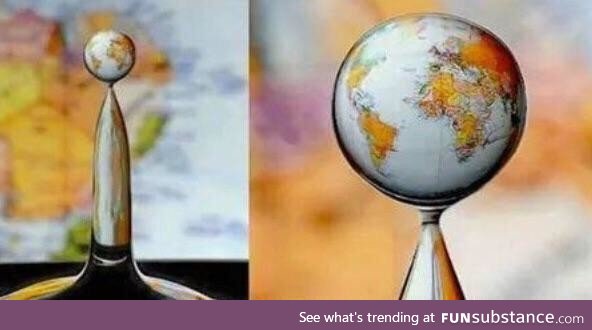 Water droplet “creates” the globe due to the nature of refraction!