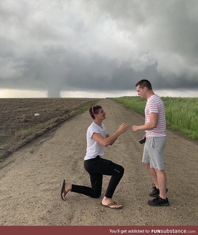 Storm chaser proposes with Kansas tornado in the background