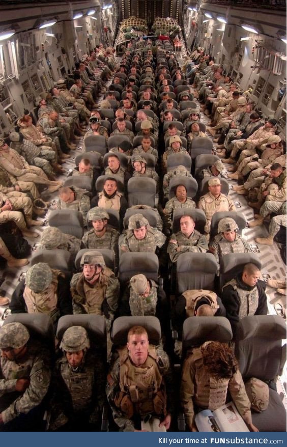Soldiers Coming Home From War. Rare view inside a military transport