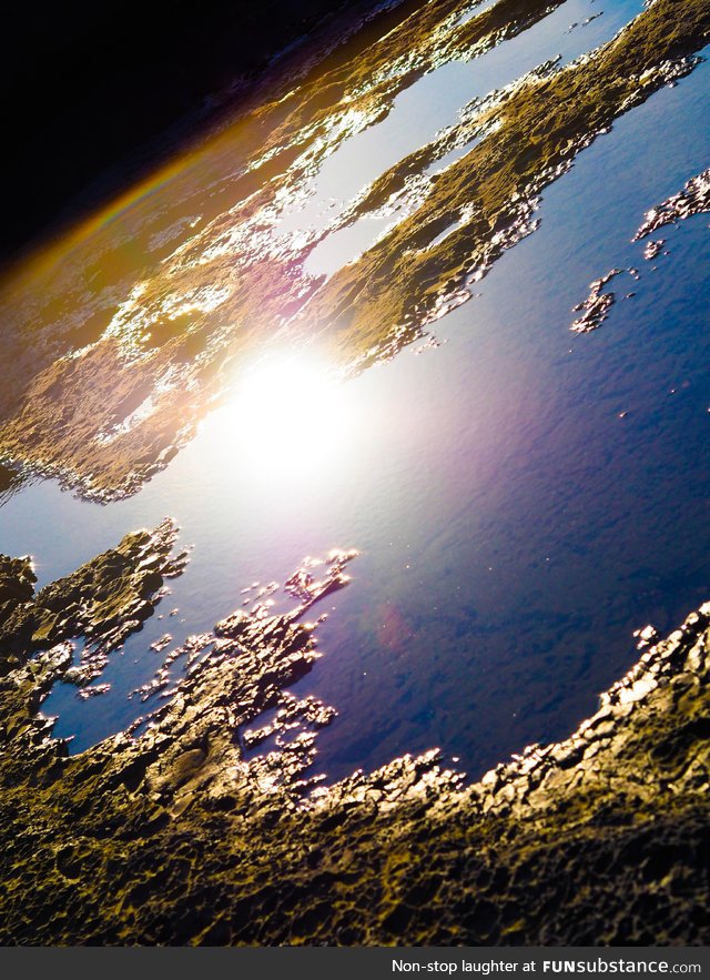 Light reflected on a puddle looks like another planet