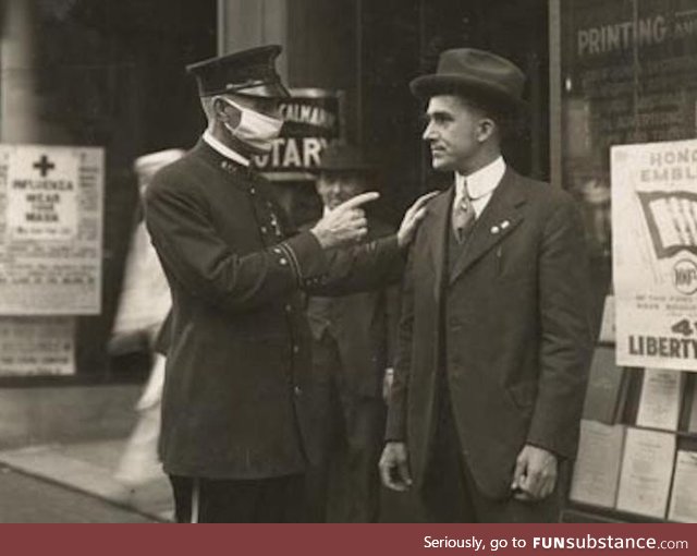 San Fransisco police officer scolding a man for not wearing a mask during the 1918