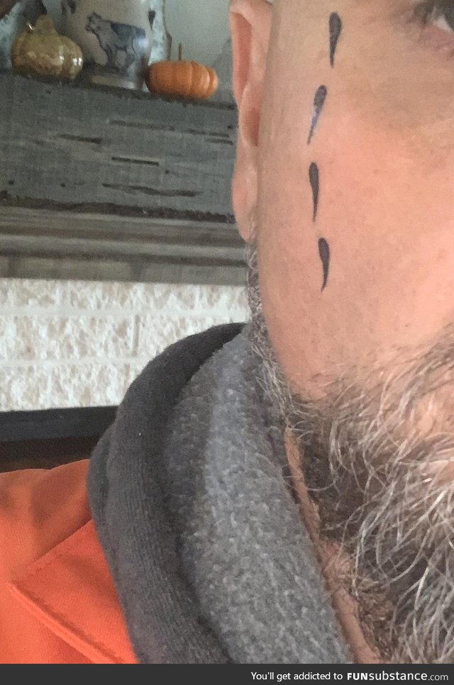 Dressing up as a convict to pass out candy. Wife put fake tear tattoos on upside down
