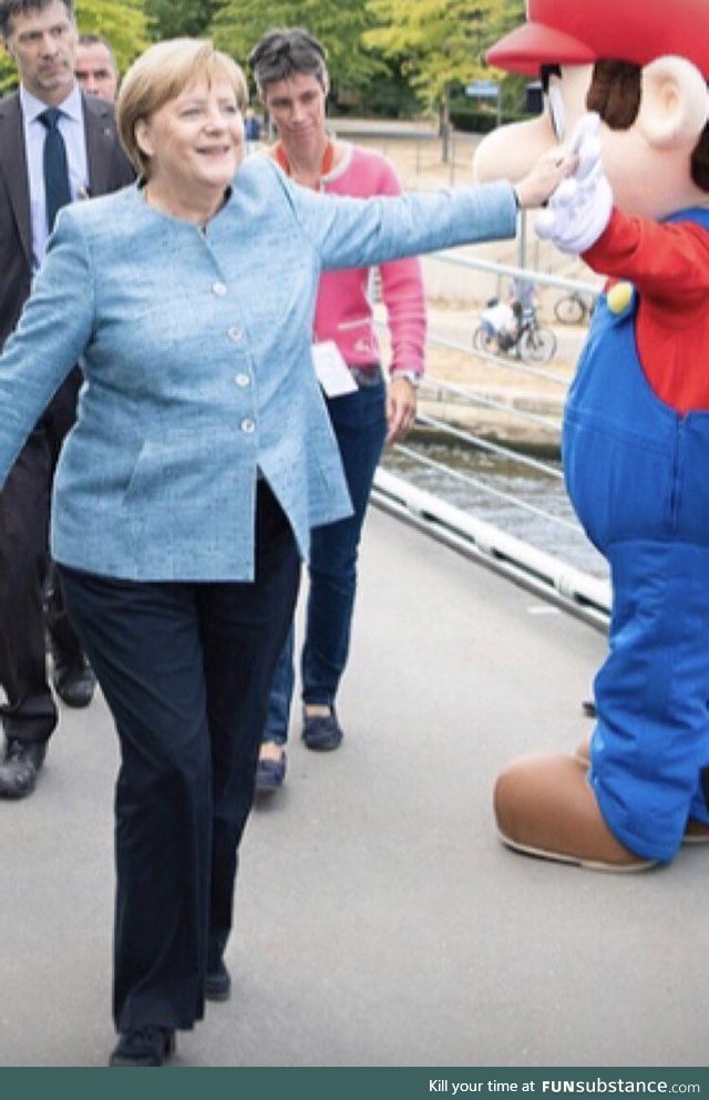 Chancellor Merkel casually high fiving Mario