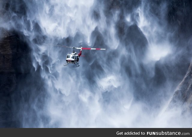 A helicopter near Yosemite waterfall, USA