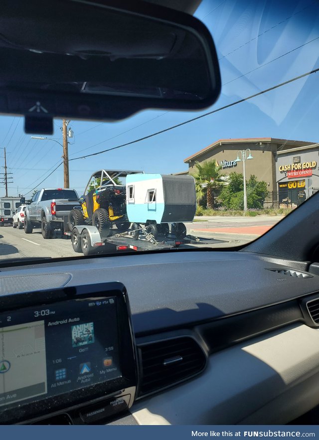 A truck towing a buggy that's towing a teeny tiny camper. It's like the nesting doll of