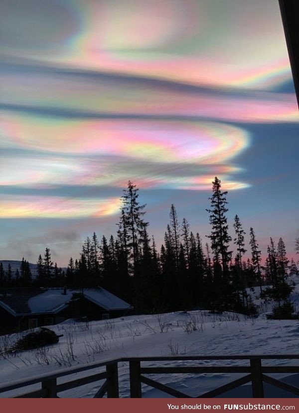 A rare phenomenon called nacreous clouds. They are formed high up in the atmosphere, at