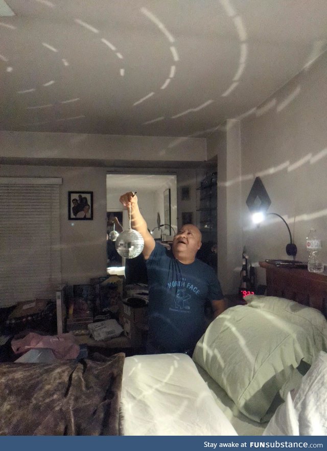 My Dad happily showing me the disco ball he bought for our quarantine new years