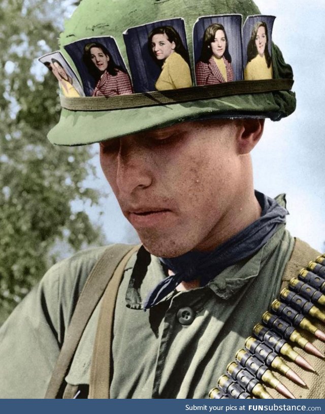 US soldier with pictures of his girlfriend, Chu Chi base camp, Vietnam 1968