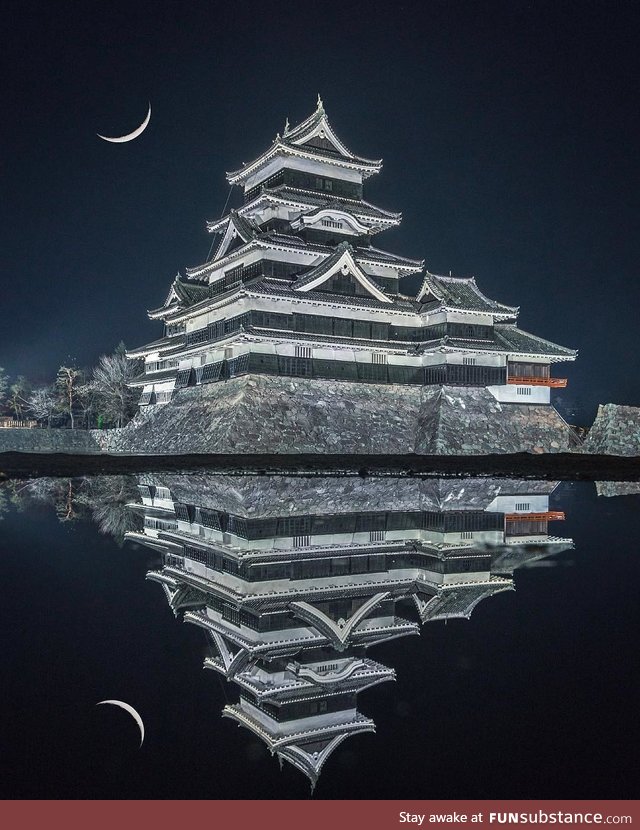 Matsumoto Castle looking like an evil fortress reflecting off the water