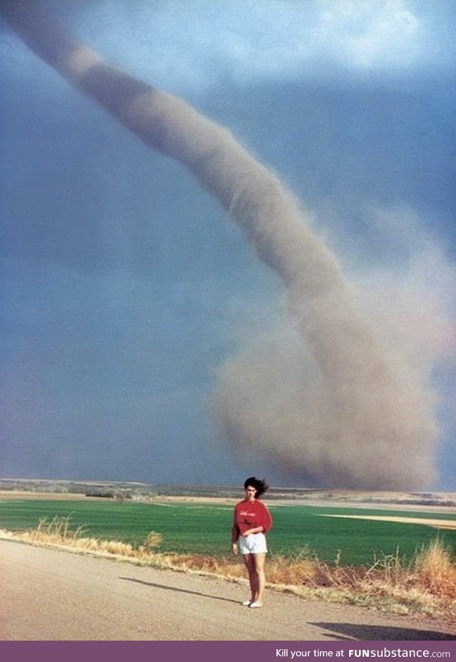 Just a woman posing with a tornado in Nebraska, 1989