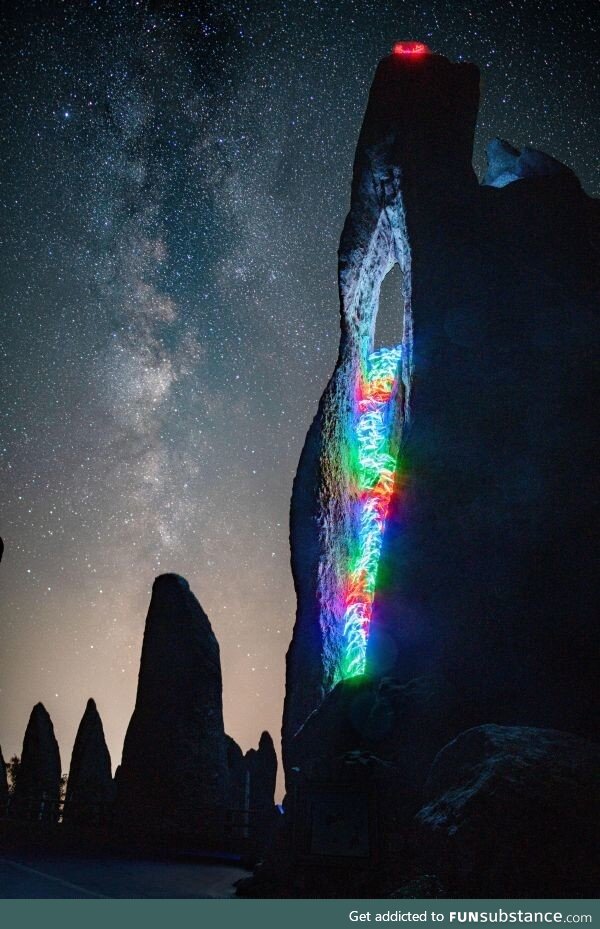 Rock climbing with LEDs tied to my body under the Milky Way