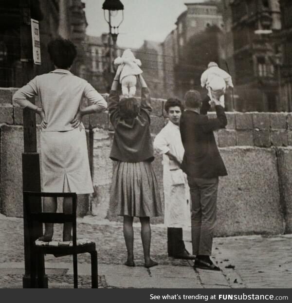 Residents of West Berlin checking for snipers, 1961