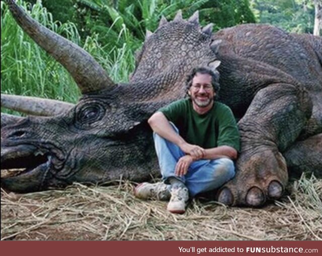 A hunter with the last remaining dinosaur he killed, making these animals officially