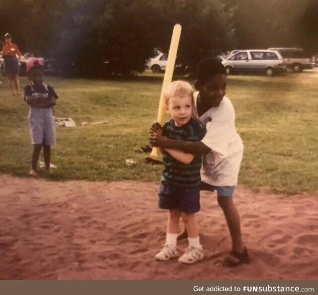 An old Polaroid of me learning how to play wiffle ball with my cousin Andre in the late
