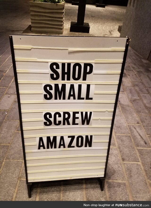 Sign near Diament Jewelry at The Wharf in Washington, DC: Shop small. Screw Amazon