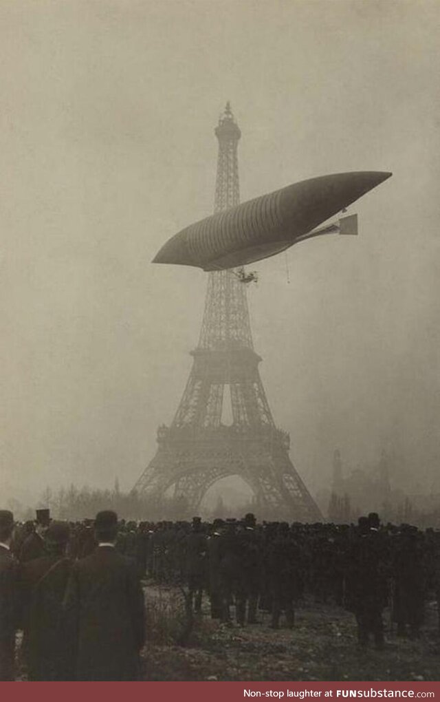 An early airship flies near the Eiffel Tower in Paris circa 1905