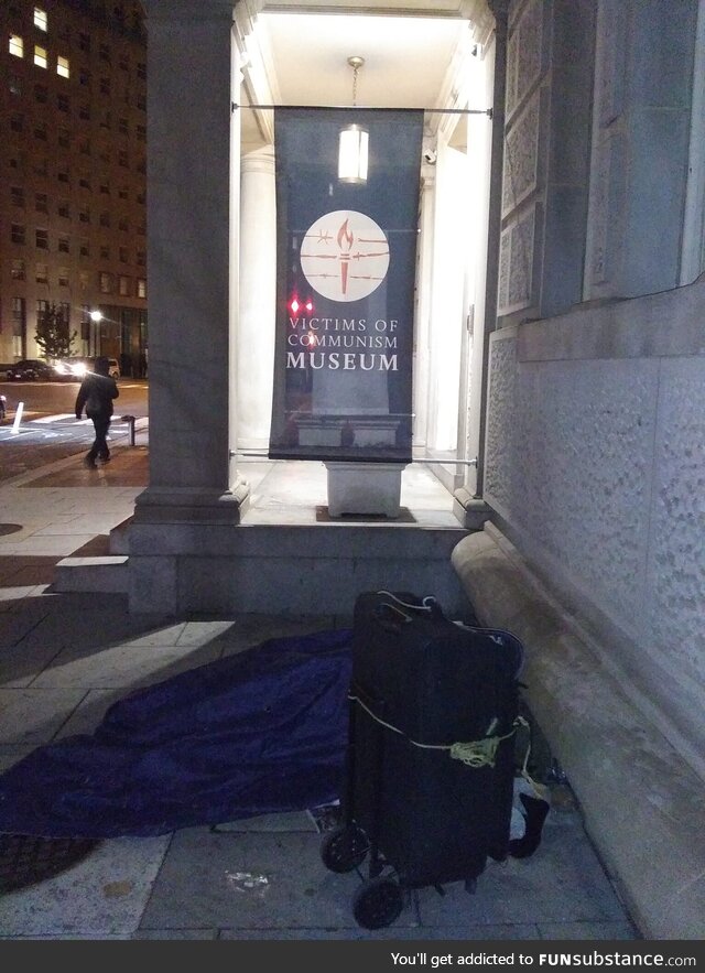 Homeless person sleeping in front of the Victims of Communism Museum in Washington DC