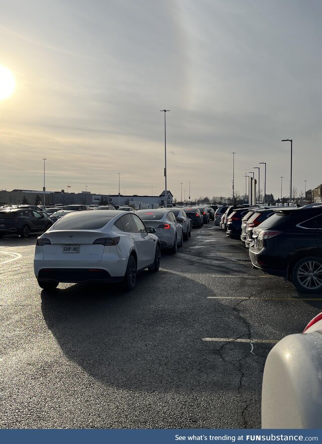 Lineup of Teslas waiting for a charging station, Vaughan Mills Ontario (Original post was