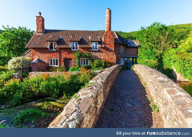 House besides a bridge and river in South West England