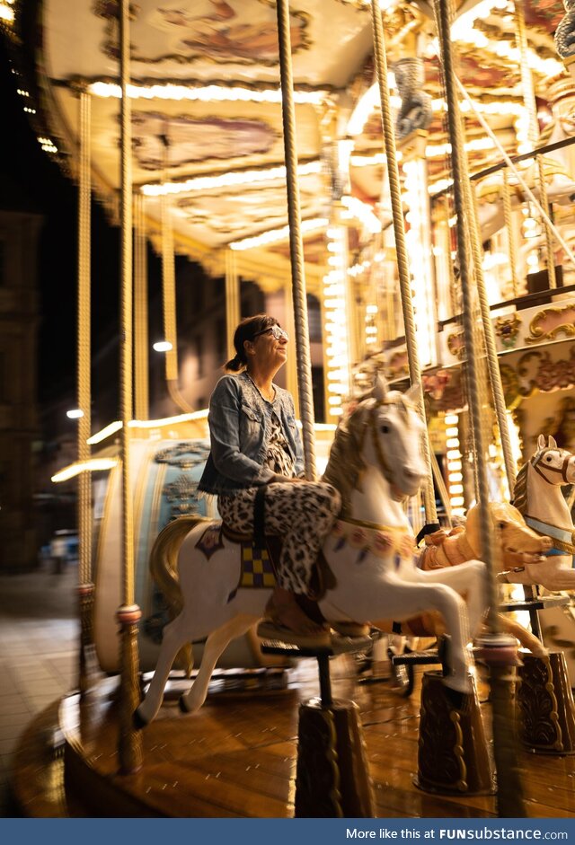 A happy lady on the carousel in Strasbourg, France