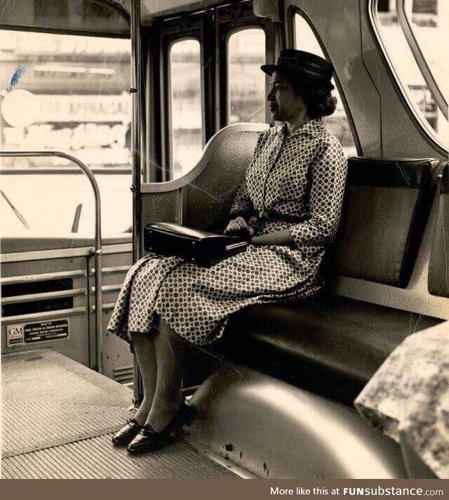 Rosa Parks sits at the front of a bus following the end of segregation by the transit