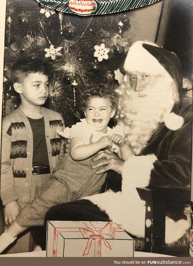 My terrified mother and unimpressed uncle meeting Santa 1955