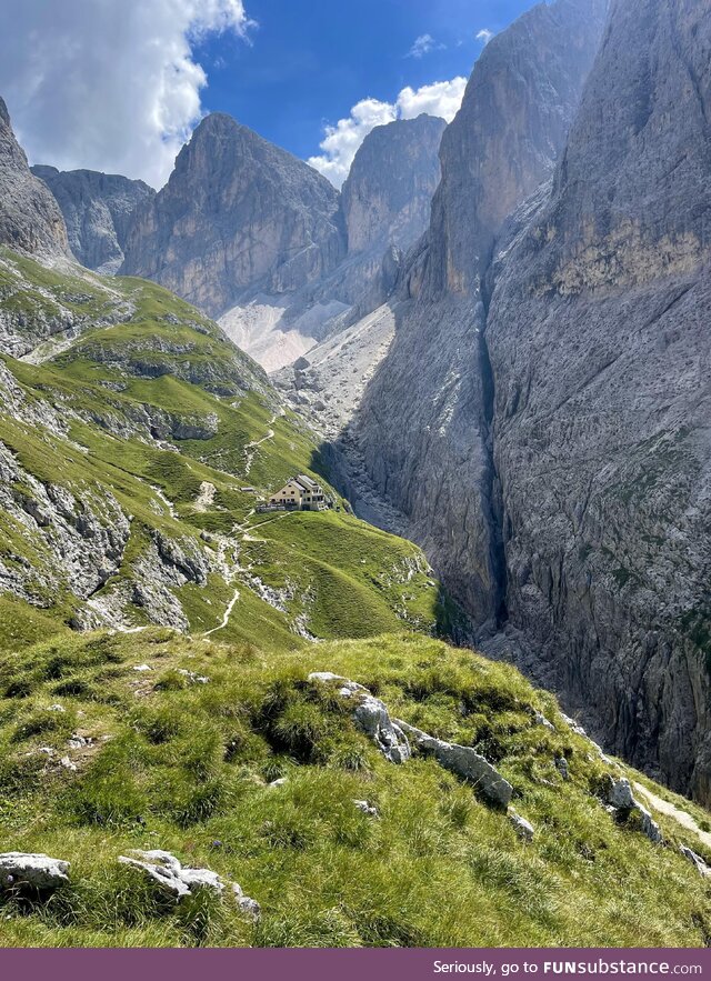 Rifugio Bergamo nestled between the peaks of the Dolomites in Sciliar Rosengarten Nature