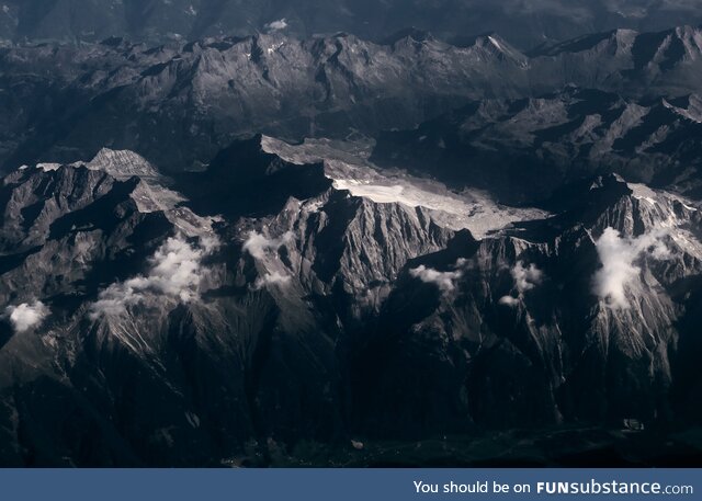 The Swiss Alps on a summer morning from the plane