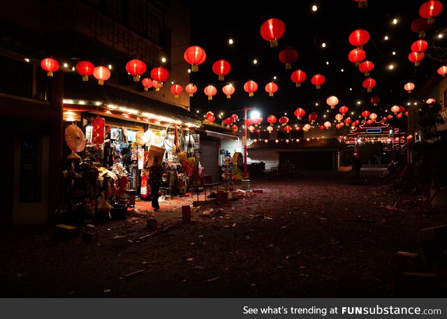 Store owner cleaning up after Lunar new year festivities in Chinatown