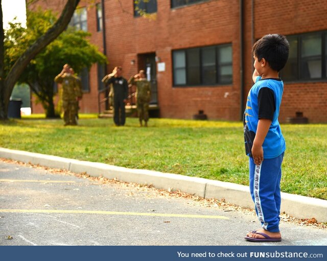 An Afghan child salutes during the US national anthem Sept. 14, 2021 at Joint Base McGuire
