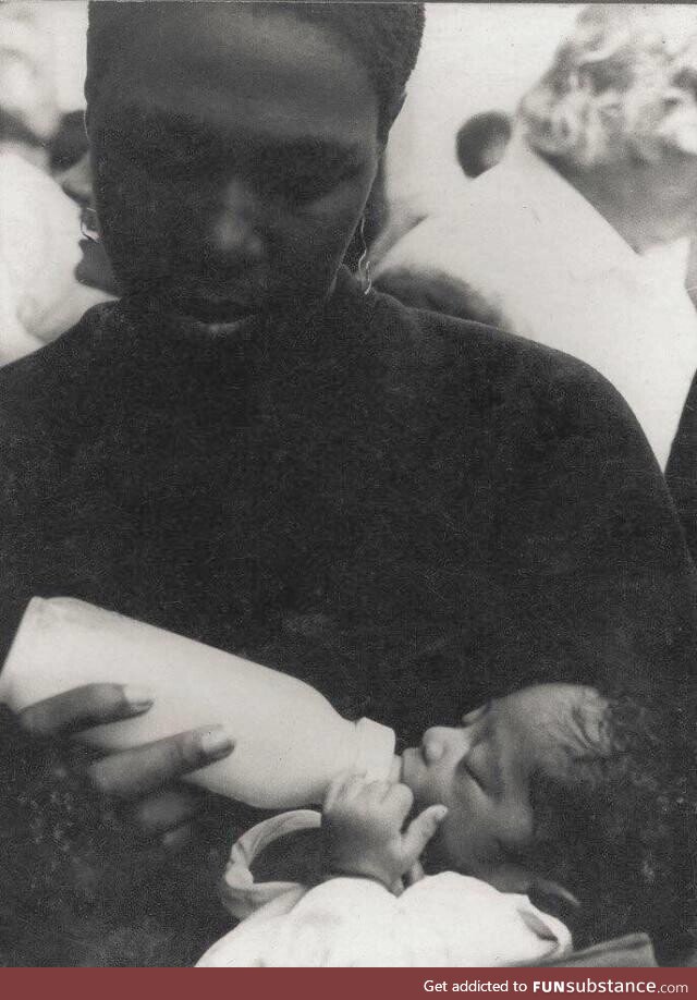 Afeni Shakur feeding a baby 2Pac at a Black Panther rally