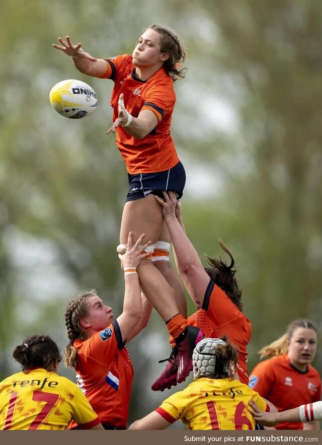 Isa Prins is lifted by her Dutch teammates during the Women's Rugby European Championship