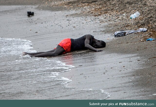 Man lies on the beach in the Spanish city Ceuta in northern Africa after swimming there