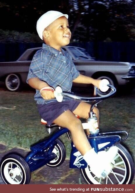 A young Barack Obama on a tricycle in 1965