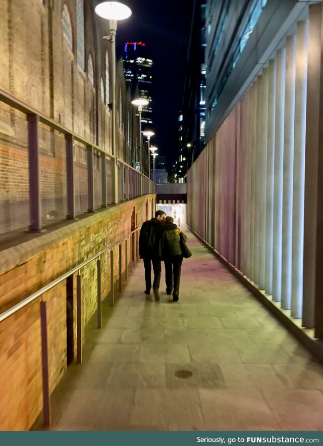 London. Late night walk home behind some happy people