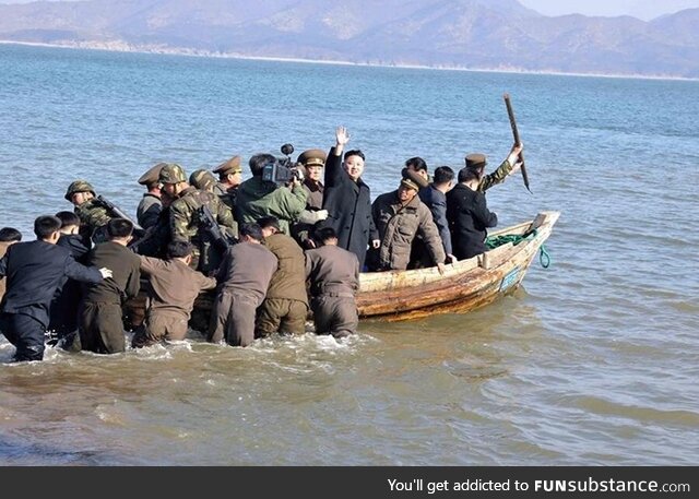 North Korean leader Kim Jong-Un waves from one of his naval ships