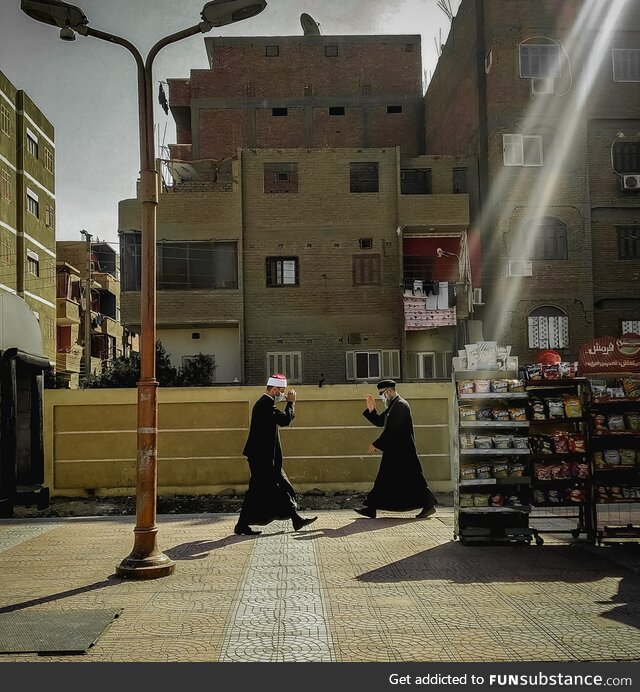 Egyptian muslim and Christian priests salute each other in the street. By Hassan Gamal