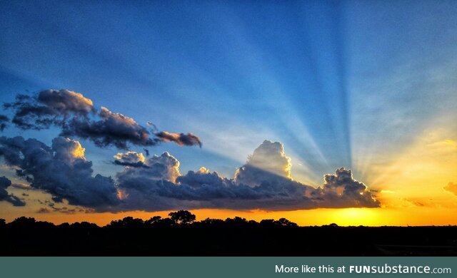 Cloud creating rays with a setting sun, houston