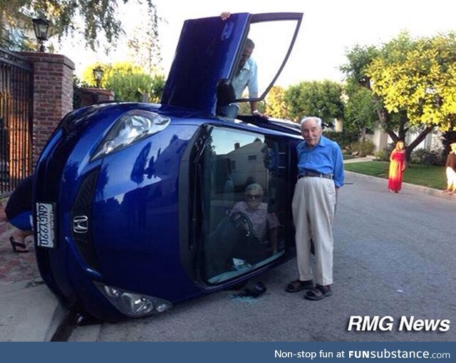 Elderly couple posing for photo after their car flipped