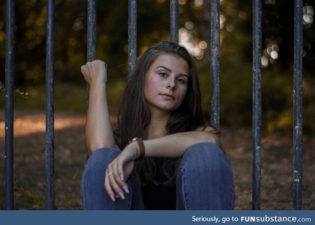 Portrait of my friend sitting at a gate