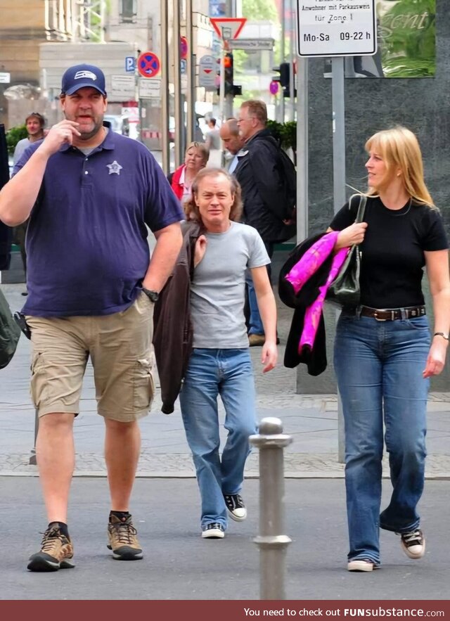 Angus Young of AC/DC with his wife and bodyguard