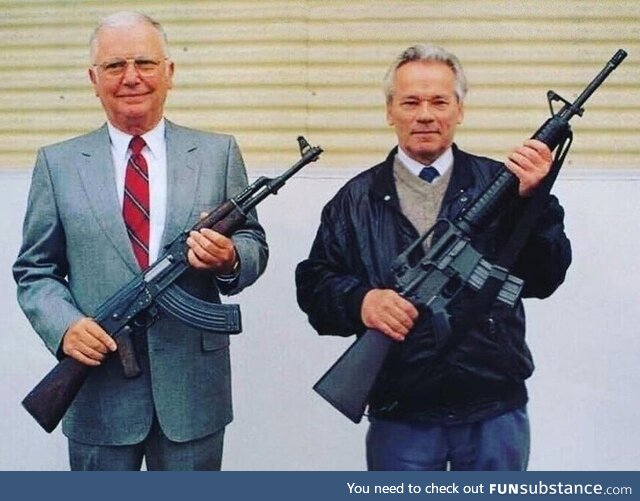 Weapons designers Stoner and Kalashnikov pose with each other's weapons, USA, 1990