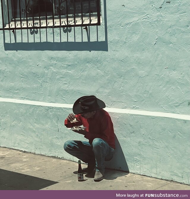 Guy eating a taco