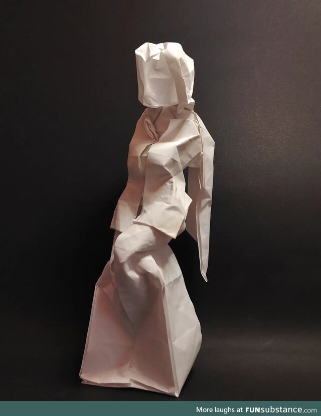 Origami seated woman, folded from a square of paper