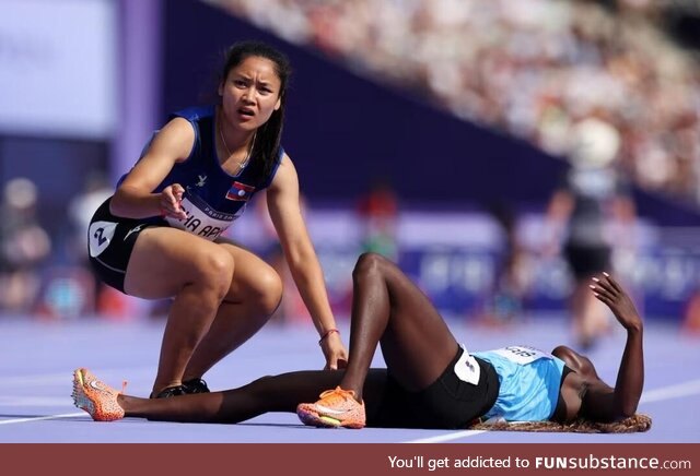 Silina Pha Aphay (Laos) comforting Lucia Moris (South Sudan) after a fall in the woman's